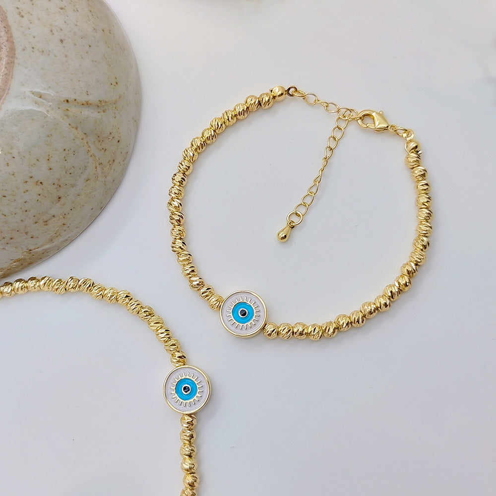 Pulsera Lucky Blue Eyes de oro bañado en cobre de 18 quilates con cuentas