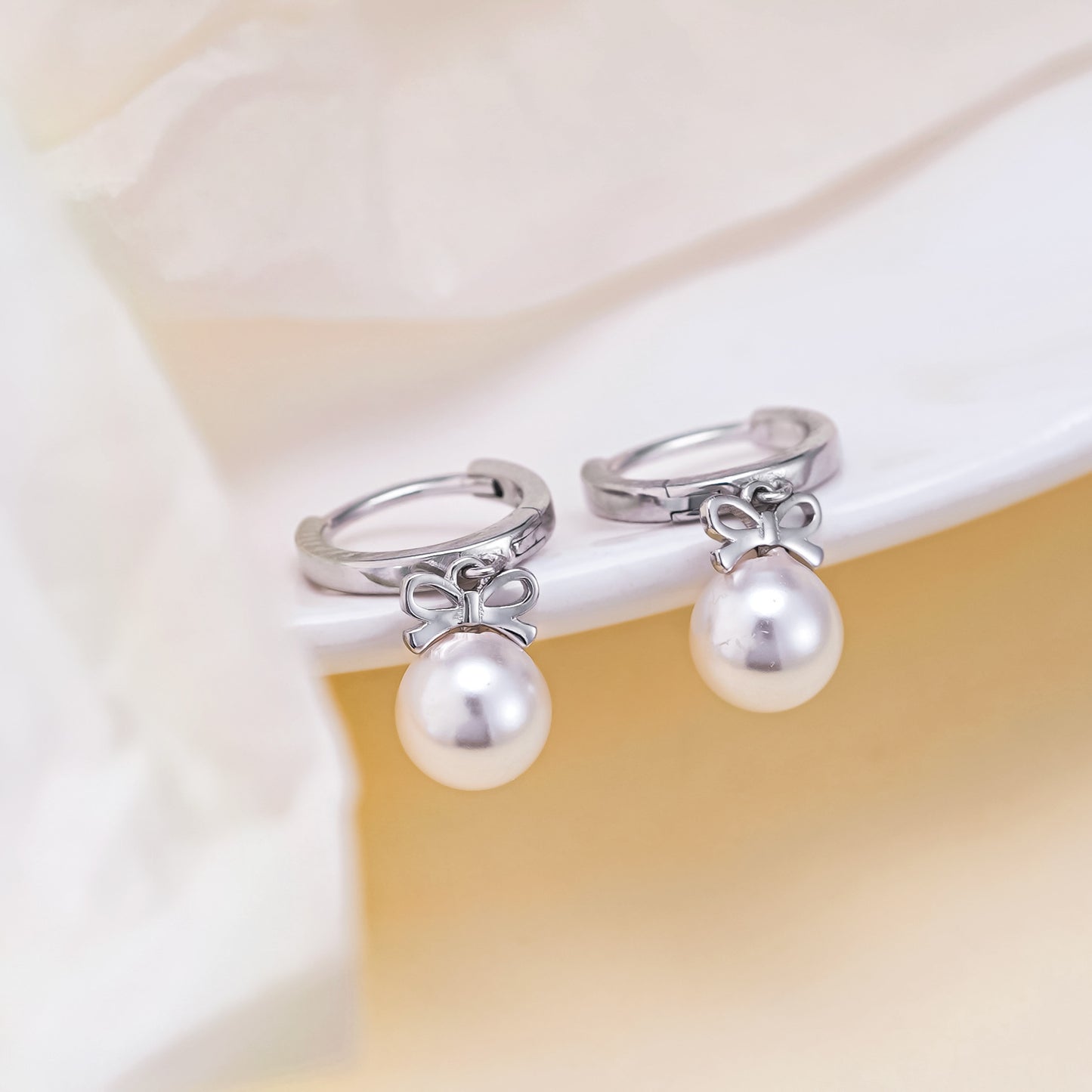 Boucles d'oreilles en perles artificielles avec nœud exquis