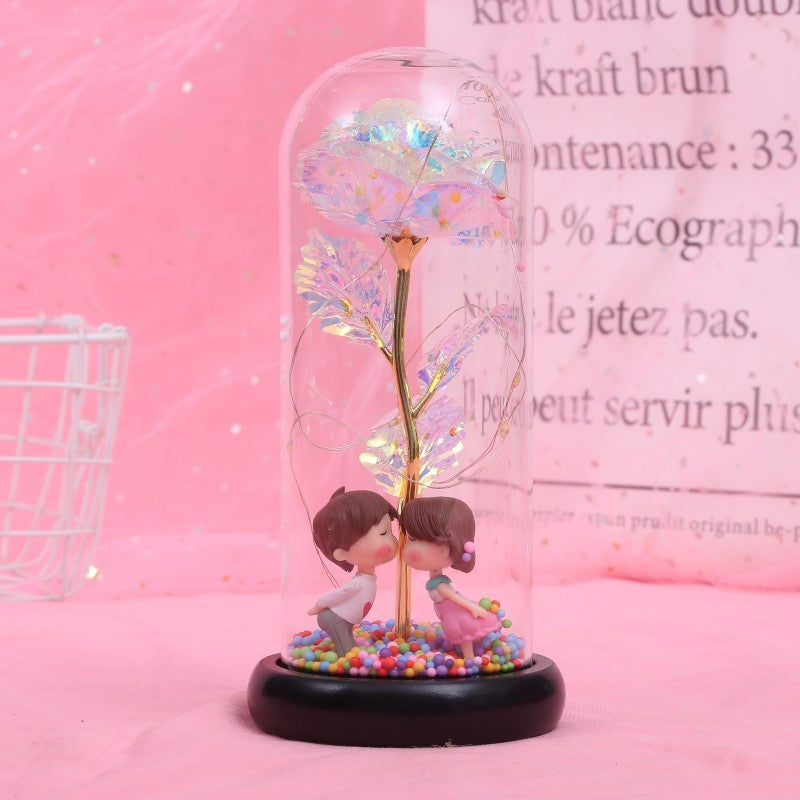Fleur de rose éternelle enchantée dans une décoration de Noël lumineuse à LED en verre