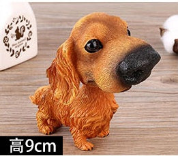 Figurines de chiot secouant la tête