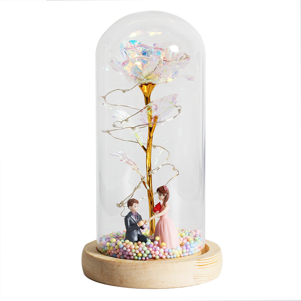 Fleur de rose éternelle enchantée dans une décoration de Noël lumineuse à LED en verre