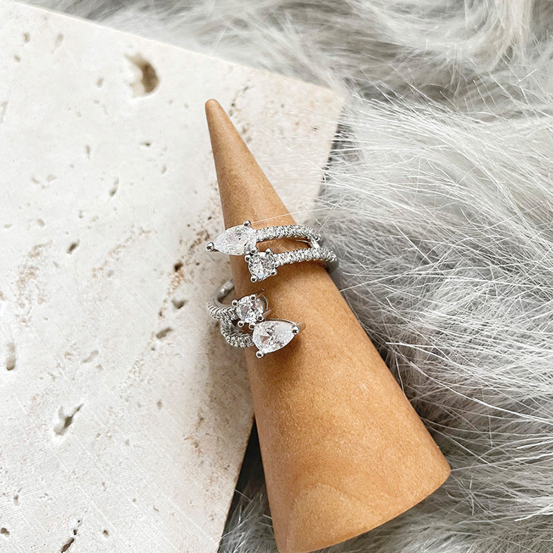 Anillo abierto de doble capa con gotas de agua y circón de viento frío
