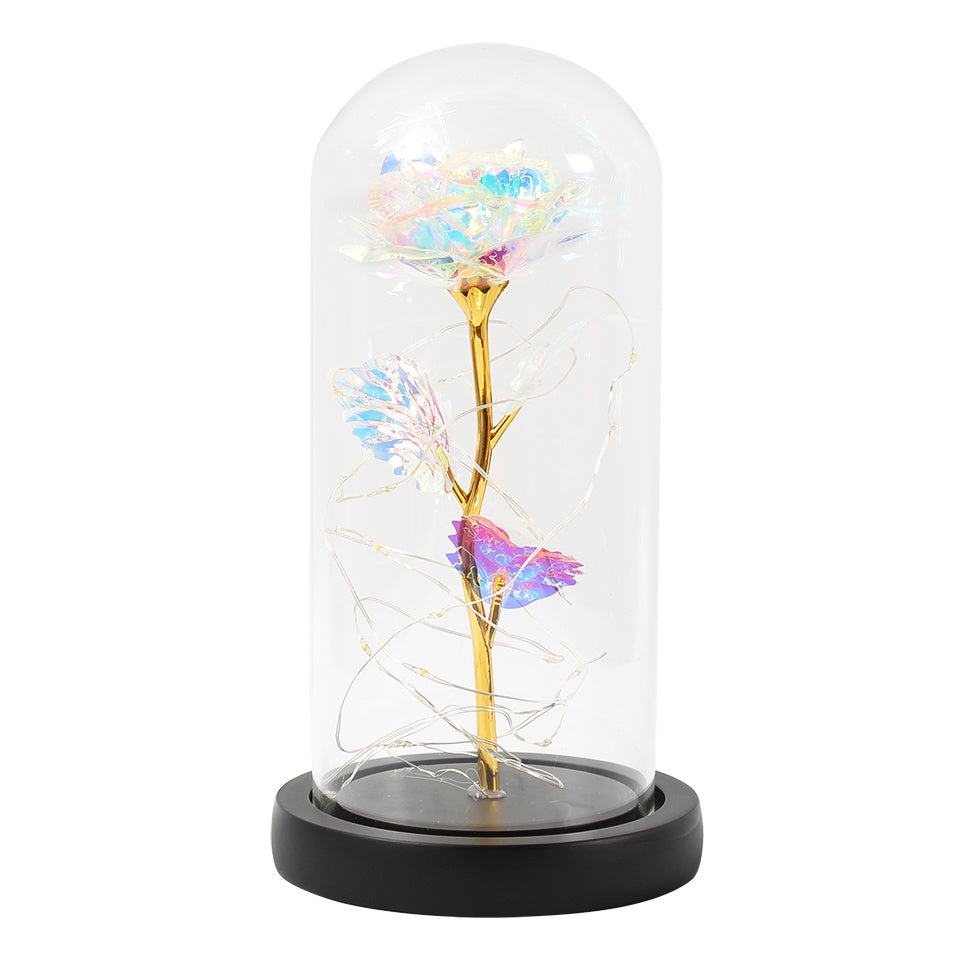Fleur de rose éternelle enchantée dans une décoration de Noël lumineuse à LED en verre