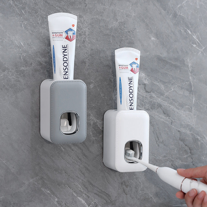 Dispensador automático de pasta de dientes montado en la pared
