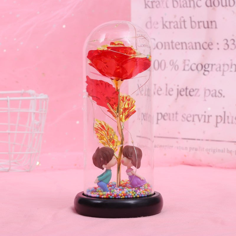 Fleur de rose éternelle enchantée dans une décoration de Noël lumineuse à LED en verre