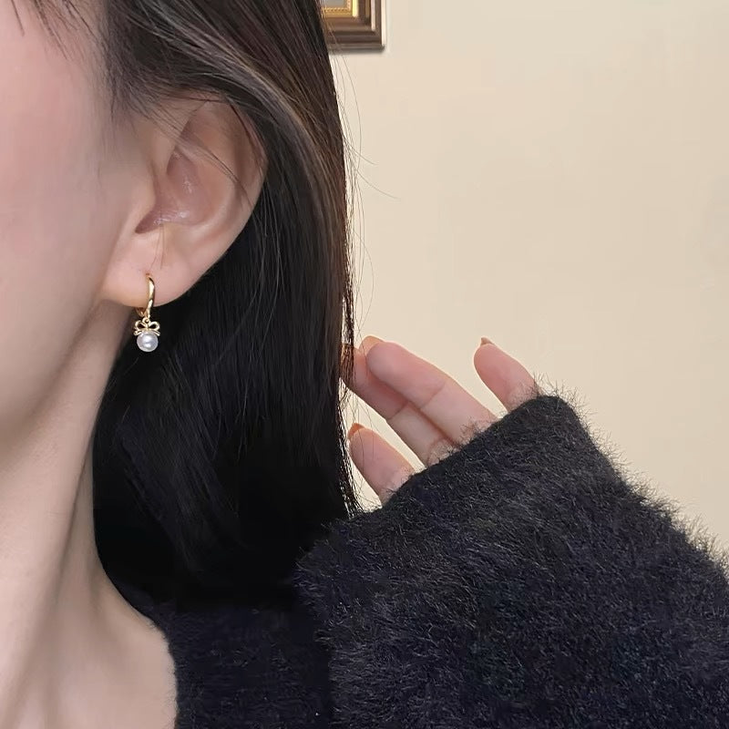 Boucles d'oreilles en perles artificielles avec nœud exquis