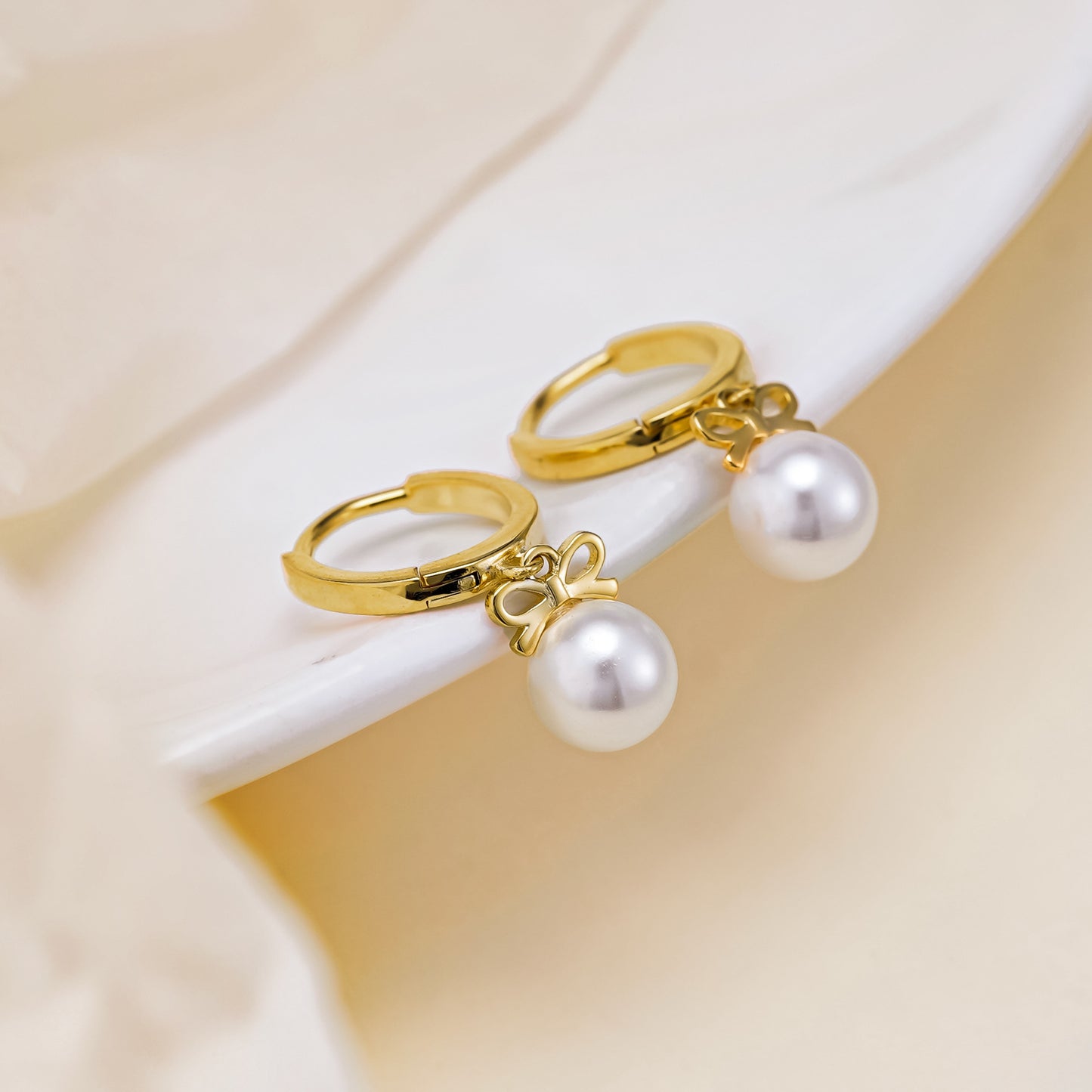 Boucles d'oreilles en perles artificielles avec nœud exquis