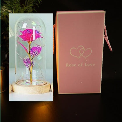 Fleur de rose éternelle enchantée dans une décoration de Noël lumineuse à LED en verre